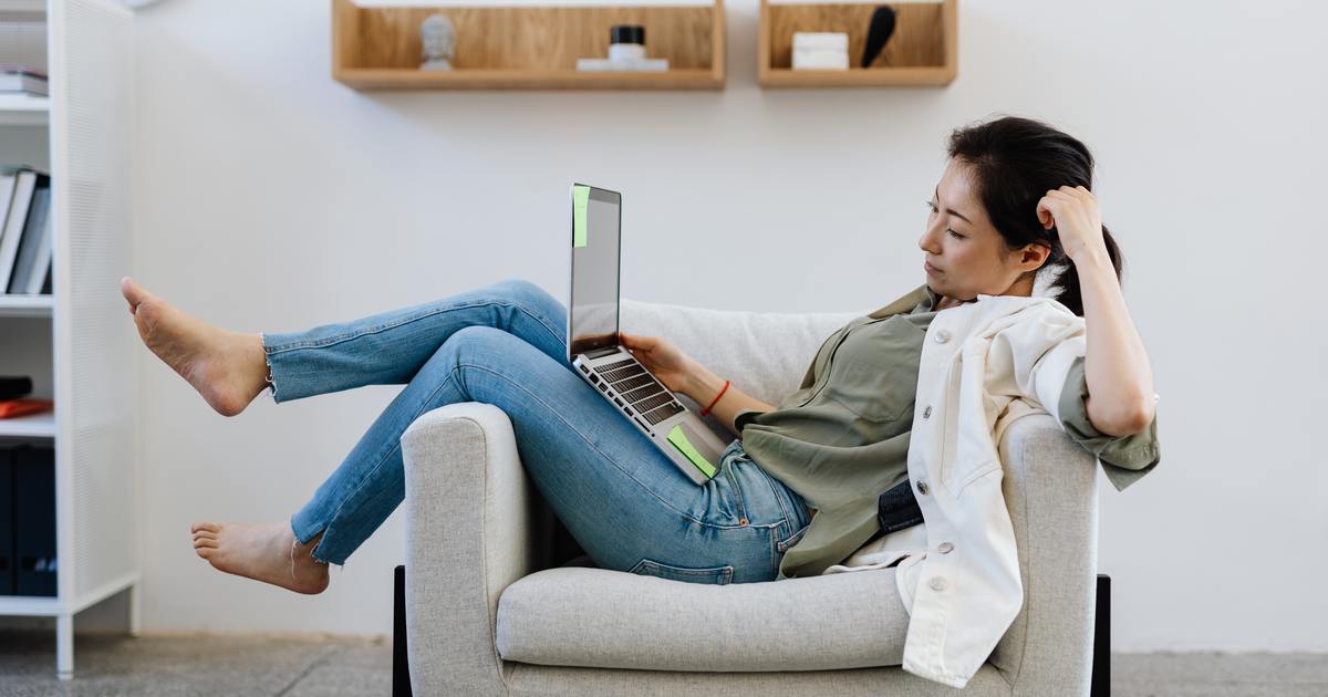 Writer laying in chair with laptop