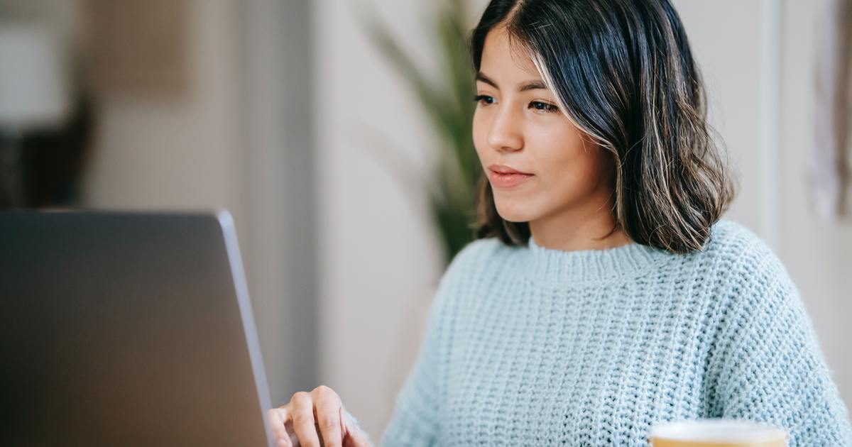 Writer typing on a laptop
